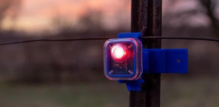 FLASHING INSULATOR SHOWS ELECTRIC FENCE IS WORKING